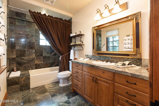 full bathroom with vanity, shower / tub combo, and toilet