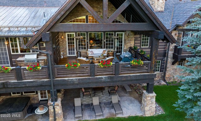 rear view of house featuring an outdoor kitchen and a patio area