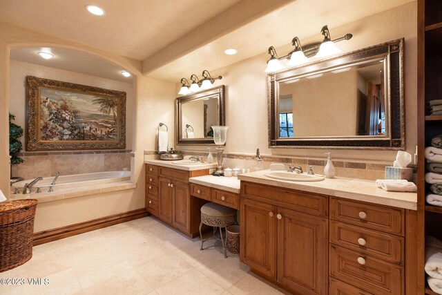 bathroom with vanity and a washtub