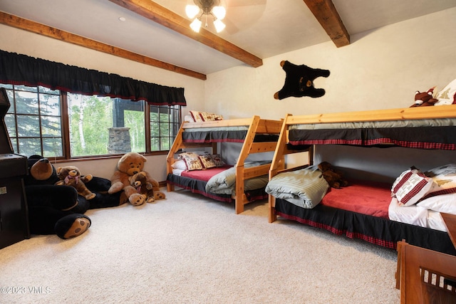 bedroom featuring beam ceiling, ceiling fan, and carpet