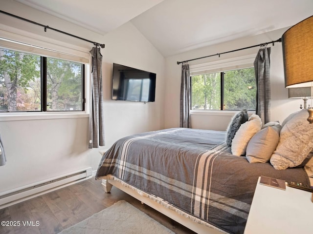 1061 W Beaver Creek Blvd Unit F-203, Avon, CO 81620 - bedroom featuring vaulted ceiling, wood finished floors, and a baseboard radiator