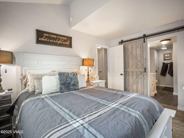 1061 W Beaver Creek Blvd Unit F-203, Avon, CO 81620 - bedroom with a barn door, baseboards, and wood finished floors