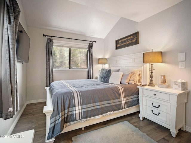 1061 W Beaver Creek Blvd Unit F-203, Avon, CO 81620 - bedroom with lofted ceiling, baseboards, and dark wood finished floors