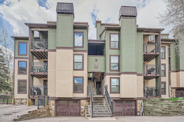1023 Lions Ridge Loop Unit 111, Vail, CO 81657 - view of apartment building / complex with a garage and stairs