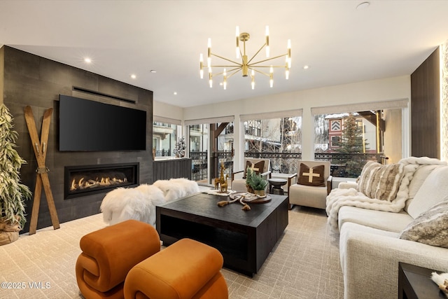 living room featuring a notable chandelier and a fireplace