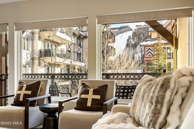 sitting room featuring a healthy amount of sunlight and a mountain view