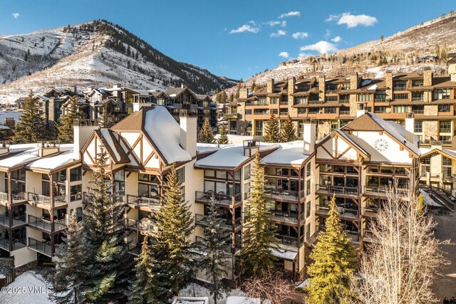 684 W Lionshead Cir Unit 302, Vail, CO 81657 - snow covered property with a mountain view and a view of apartment building / complex