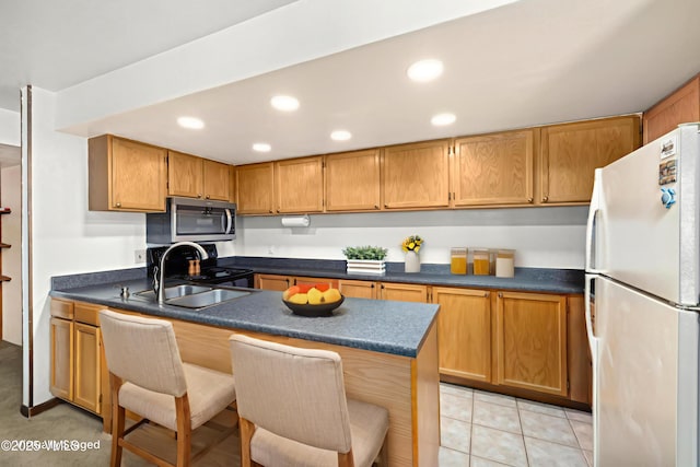 423 Wild Irishman Rd Unit 1008 1009, Keystone, CO 80435 - kitchen with appliances with stainless steel finishes, a peninsula, a breakfast bar area, dark countertops, and recessed lighting