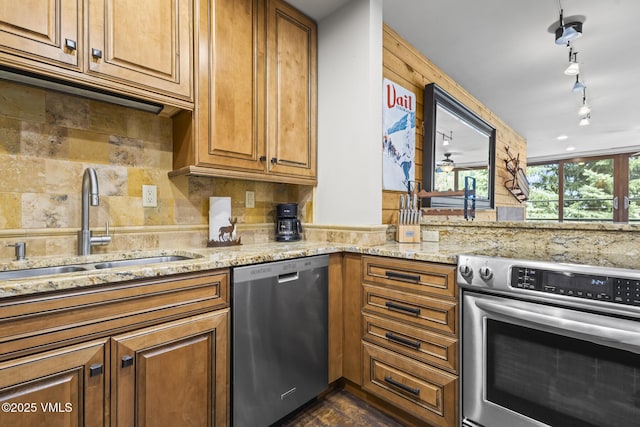 1100 N Frontage Rd W Unit 2504, Vail, CO 81657 - kitchen featuring appliances with stainless steel finishes, light stone counters, brown cabinets, and backsplash
