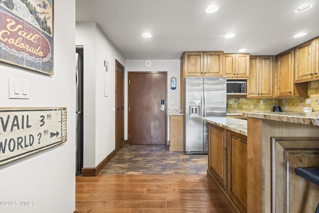 1100 N Frontage Rd W Unit 2504, Vail, CO 81657 - kitchen featuring stainless steel refrigerator with ice dispenser, dark wood-style flooring, backsplash, recessed lighting, and light stone countertops