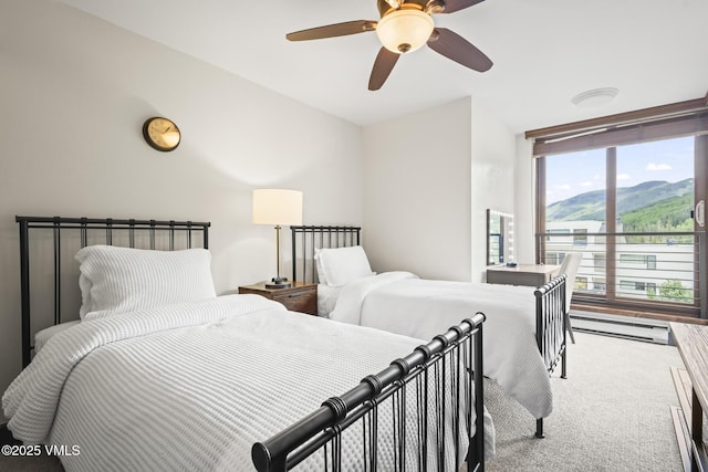 1100 N Frontage Rd W Unit 2504, Vail, CO 81657 - carpeted bedroom featuring baseboard heating, ceiling fan, and a mountain view