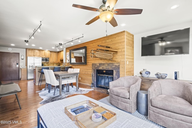 1100 N Frontage Rd W Unit 2504, Vail, CO 81657 - living room with a ceiling fan, wood finished floors, a fireplace, track lighting, and recessed lighting