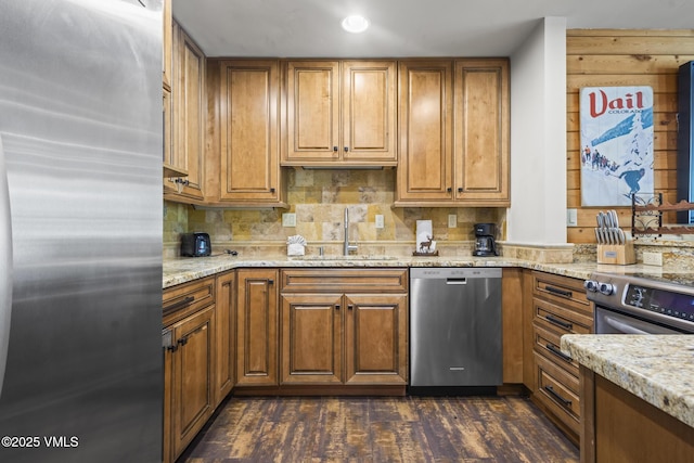 1100 N Frontage Rd W Unit 2504, Vail, CO 81657 - kitchen with stainless steel appliances, brown cabinetry, backsplash, dark wood-style flooring, and light stone countertops