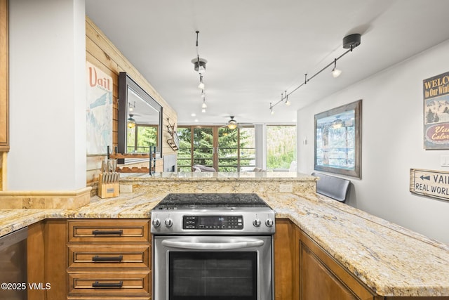1100 N Frontage Rd W Unit 2504, Vail, CO 81657 - kitchen with stainless steel appliances, brown cabinets, and light stone countertops