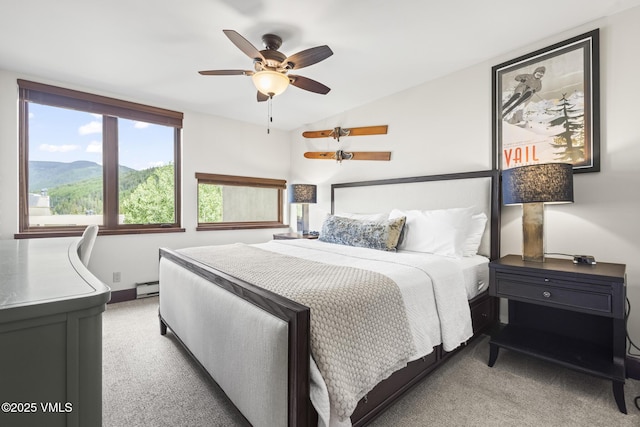 1100 N Frontage Rd W Unit 2504, Vail, CO 81657 - bedroom featuring light carpet, a baseboard radiator, lofted ceiling, ceiling fan, and a mountain view
