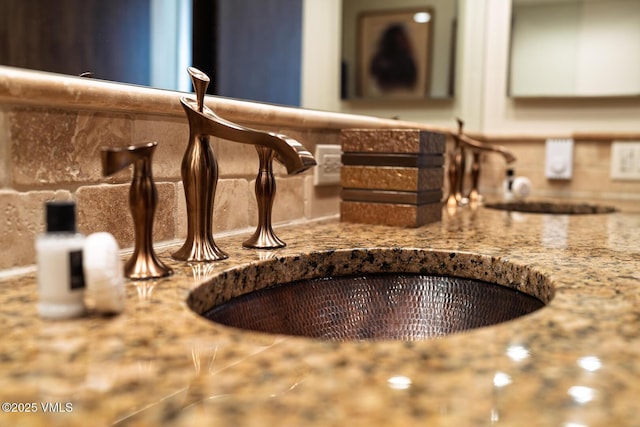 details featuring a sink and decorative backsplash