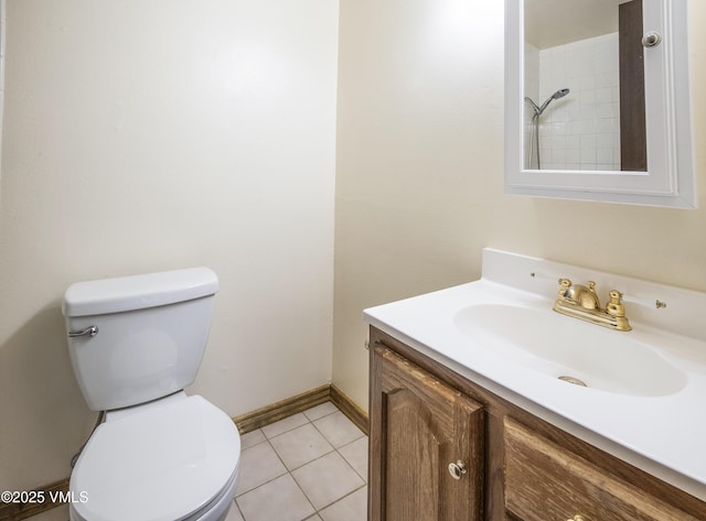 bathroom featuring baseboards, toilet, tile patterned flooring, and vanity