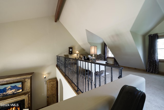 interior space with vaulted ceiling with beams and carpet floors