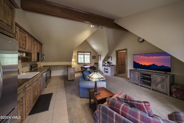 living room featuring light colored carpet, lofted ceiling with beams, track lighting, and light tile patterned floors