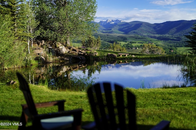 view of water feature featuring fence and a mountain view