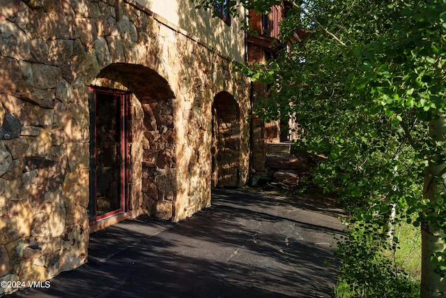 view of side of home with stone siding