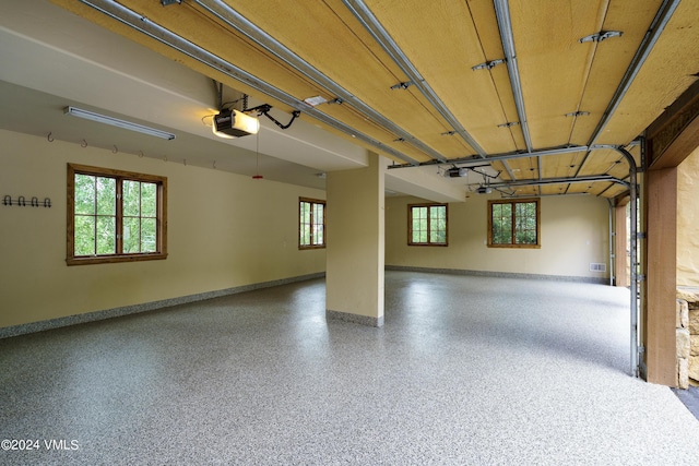 garage with baseboards and a garage door opener