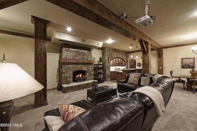 carpeted living area with baseboards, a fireplace, ornamental molding, and beamed ceiling