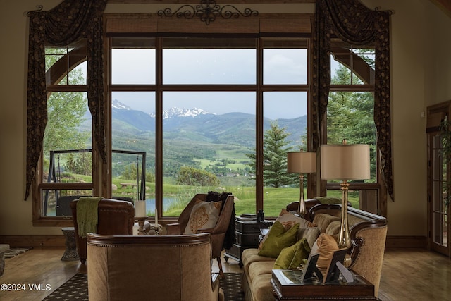 sunroom featuring a mountain view and a healthy amount of sunlight