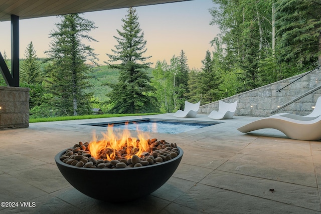 307 Rockledge Rd, Vail, CO 81657 - pool at dusk with an outdoor fire pit, a patio, and an outdoor pool
