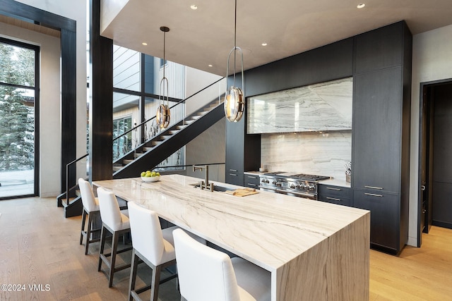 307 Rockledge Rd, Vail, CO 81657 - kitchen featuring stainless steel stove, modern cabinets, light wood-type flooring, and recessed lighting
