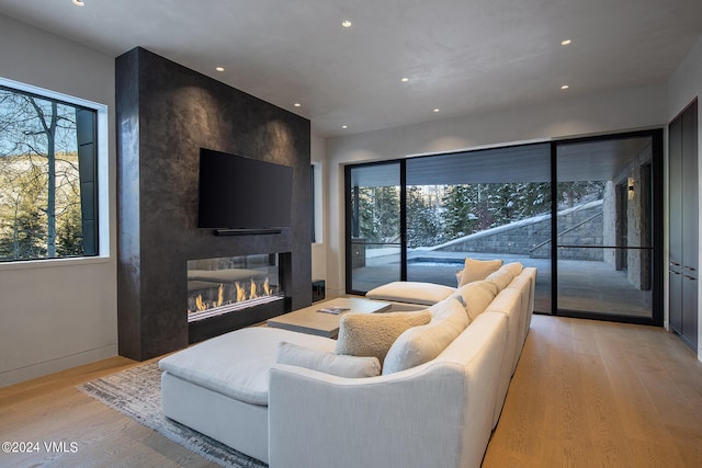 307 Rockledge Rd, Vail, CO 81657 - living room featuring a large fireplace, recessed lighting, and light wood-style floors