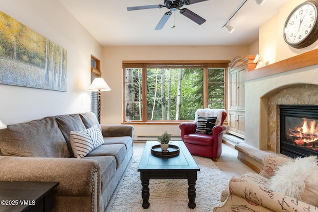 627 Sawatch Dr Unit 105, Edwards, CO 81632 - living room with rail lighting, a ceiling fan, a fireplace, and a baseboard heating unit