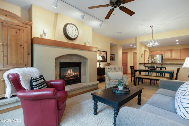 627 Sawatch Dr Unit 105, Edwards, CO 81632 - living area with a ceiling fan, track lighting, a premium fireplace, and light carpet