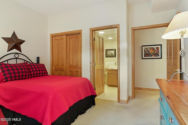 627 Sawatch Dr Unit 105, Edwards, CO 81632 - bedroom with light colored carpet, a closet, and ensuite bath