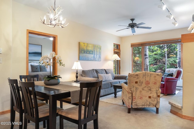 627 Sawatch Dr Unit 105, Edwards, CO 81632 - dining room featuring light colored carpet, a chandelier, a ceiling fan, and rail lighting