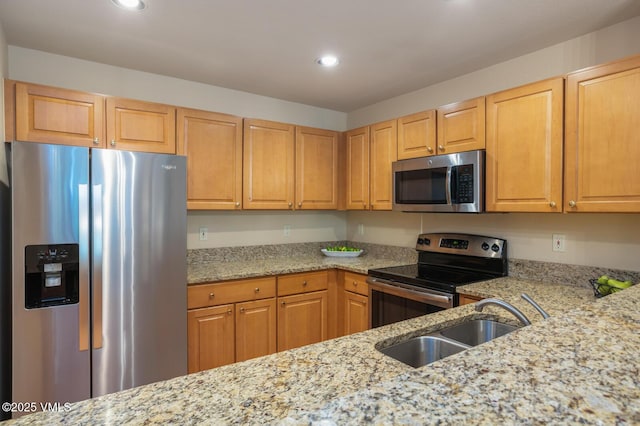 627 Sawatch Dr Unit 105, Edwards, CO 81632 - kitchen with stainless steel appliances, recessed lighting, and light stone counters