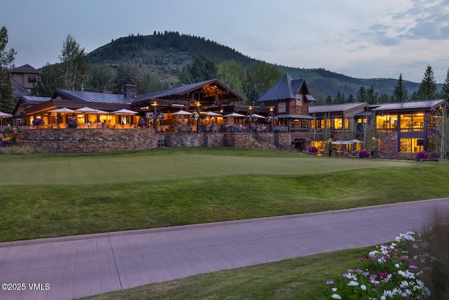 627 Sawatch Dr Unit 105, Edwards, CO 81632 - surrounding community featuring an area to practice putting, a mountain view, and a lawn