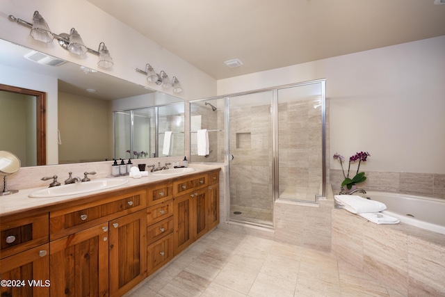 bathroom featuring vanity and independent shower and bath