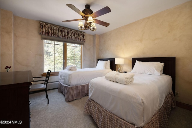 carpeted bedroom featuring baseboard heating and ceiling fan