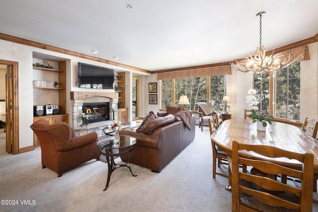 carpeted living room featuring built in shelves, a stone fireplace, and an inviting chandelier