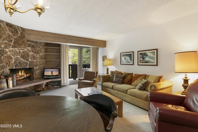 103 Willow Pl Unit 203, Vail, CO 81657 - living area featuring carpet flooring, a textured ceiling, a fireplace, and a chandelier