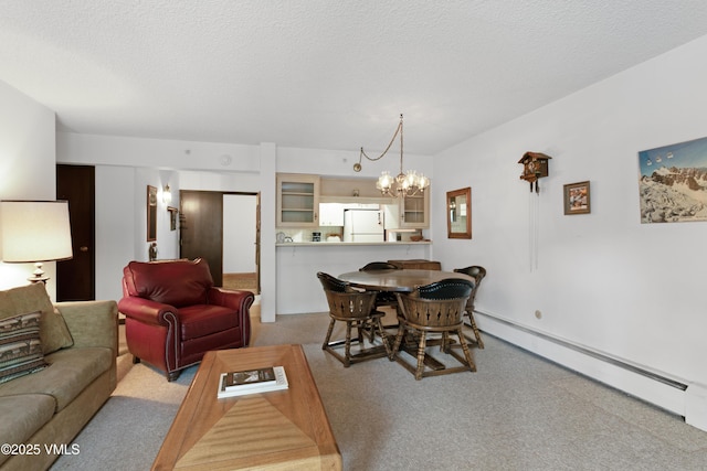103 Willow Pl Unit 203, Vail, CO 81657 - living area with baseboard heating, carpet, a chandelier, and a textured ceiling