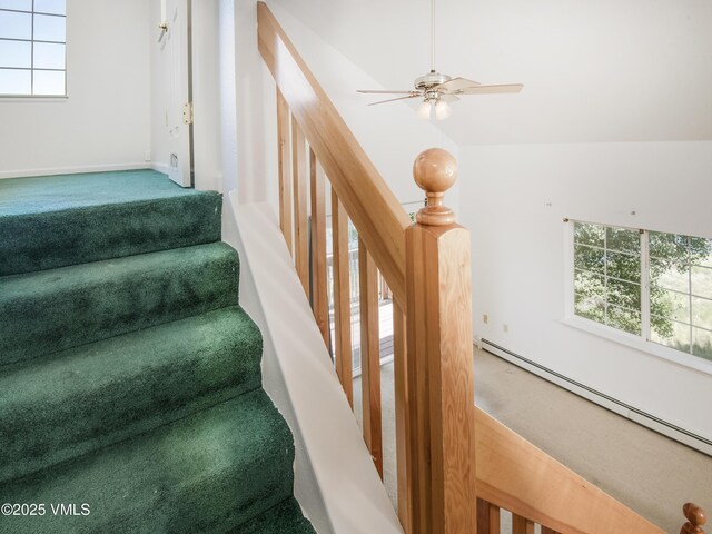 205 Crazy Horse Pt Unit 205, Edwards, CO 81632 - stairway with a baseboard heating unit, a ceiling fan, and carpet flooring