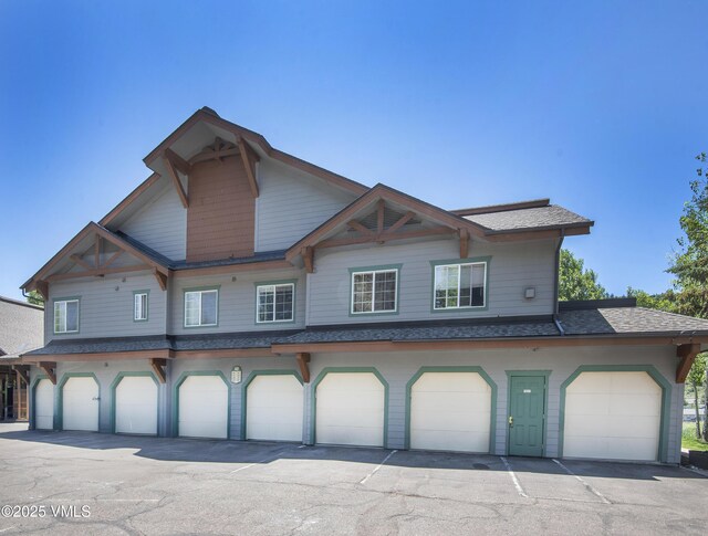 205 Crazy Horse Pt Unit 205, Edwards, CO 81632 - view of front of house featuring a shingled roof and an attached garage