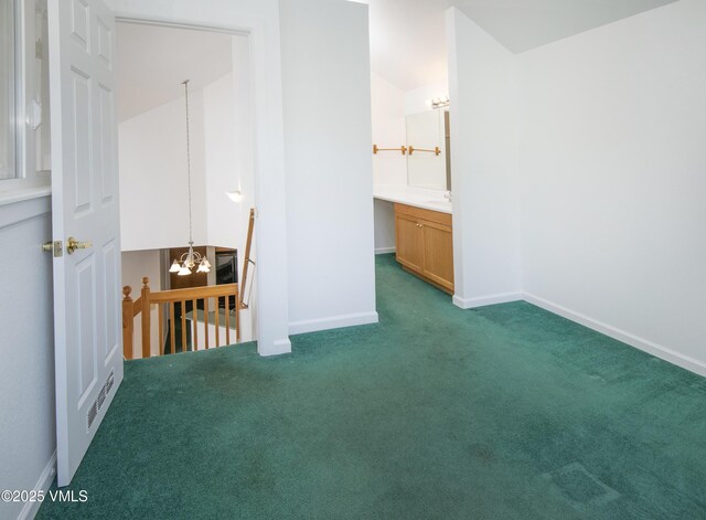 205 Crazy Horse Pt Unit 205, Edwards, CO 81632 - unfurnished bedroom with a chandelier and carpet