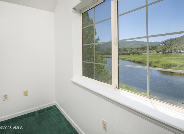 205 Crazy Horse Pt Unit 205, Edwards, CO 81632 - carpeted spare room featuring a water and mountain view and baseboards