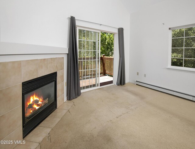205 Crazy Horse Pt Unit 205, Edwards, CO 81632 - unfurnished living room with a fireplace, carpet floors, healthy amount of natural light, and baseboard heating