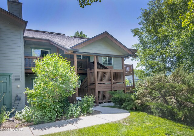 205 Crazy Horse Pt Unit 205, Edwards, CO 81632 - rear view of property featuring a chimney and a shingled roof