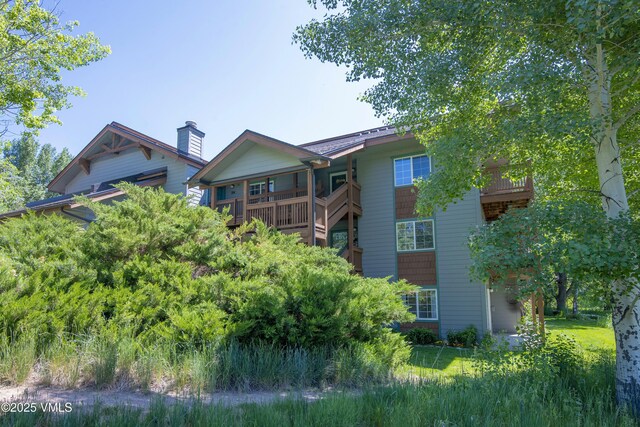 205 Crazy Horse Pt Unit 205, Edwards, CO 81632 - rear view of property with a balcony and a chimney