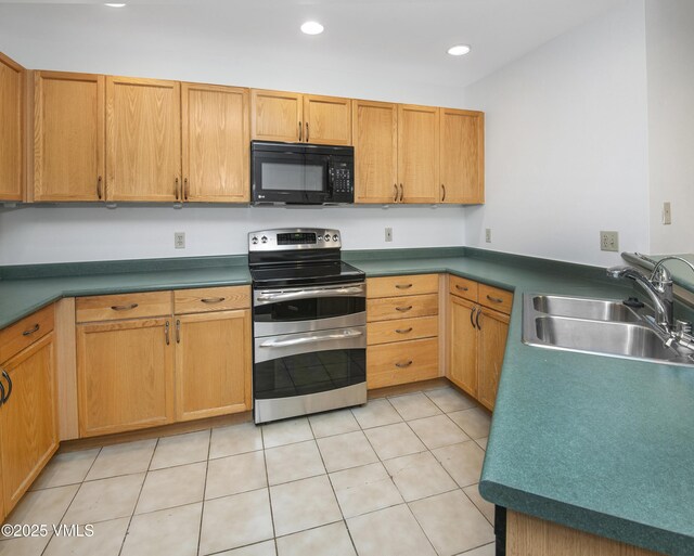 205 Crazy Horse Pt Unit 205, Edwards, CO 81632 - kitchen featuring black microwave, range with two ovens, light tile patterned floors, and recessed lighting